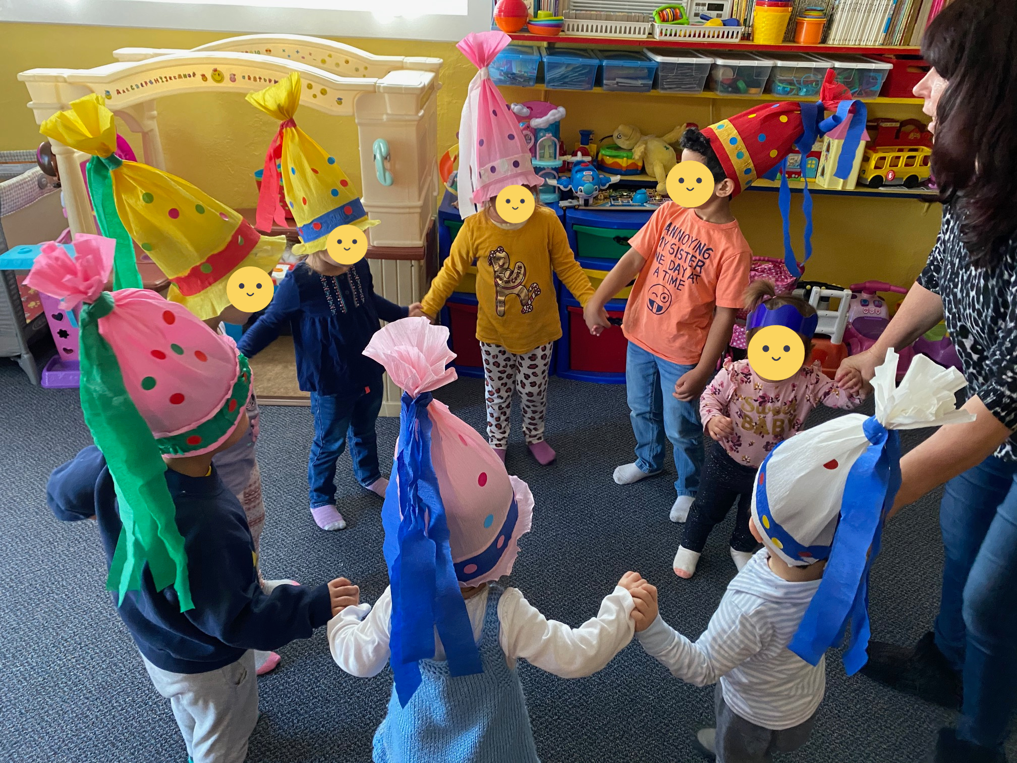 Lucy talking to kids while in a play circle.